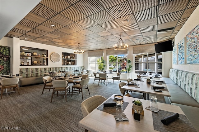 dining space featuring an inviting chandelier and carpet