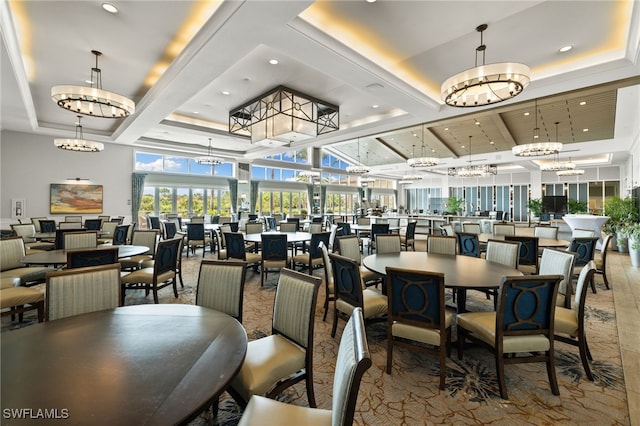 dining area with recessed lighting, a raised ceiling, and a notable chandelier