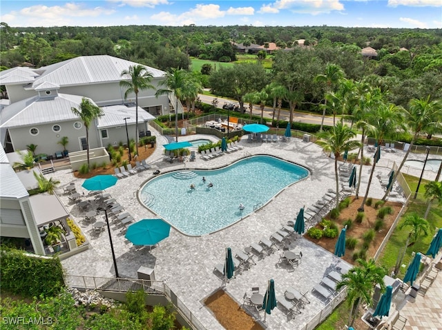 community pool featuring a patio and fence