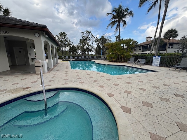 pool featuring a patio area and fence