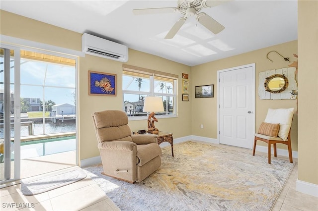 living area featuring ceiling fan, an AC wall unit, baseboards, and light tile patterned floors