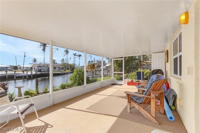 sunroom / solarium with a water view