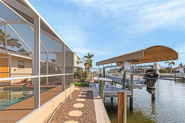 view of dock with boat lift, glass enclosure, and a water view