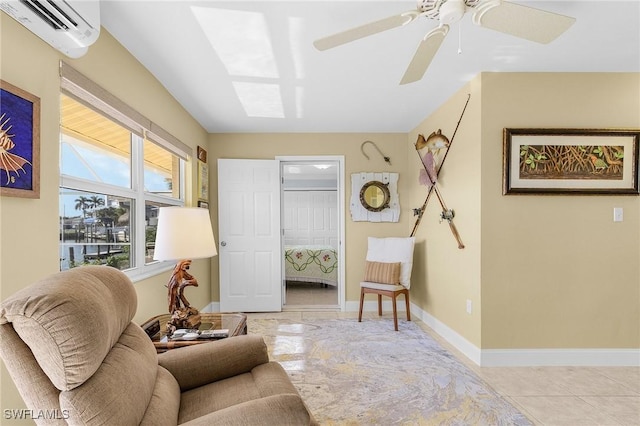 living area with tile patterned flooring, baseboards, a wall unit AC, and a ceiling fan