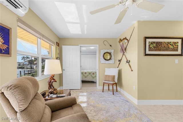 sitting room featuring baseboards, tile patterned flooring, a ceiling fan, and an AC wall unit