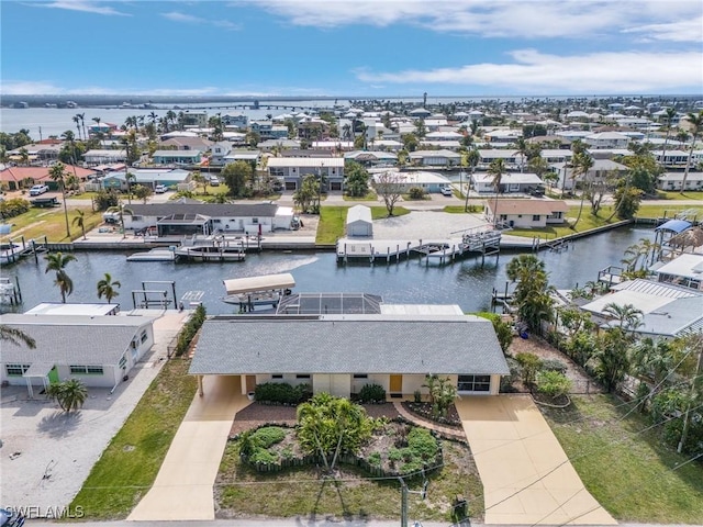 drone / aerial view with a water view and a residential view