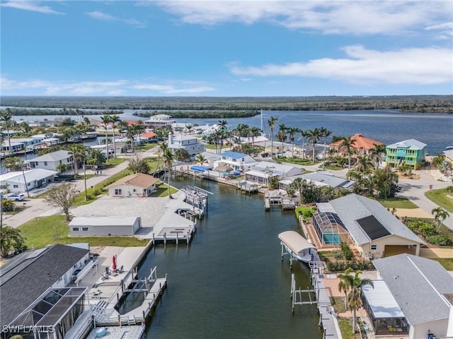 birds eye view of property featuring a water view and a residential view