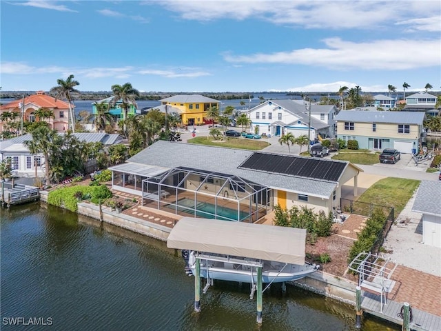 birds eye view of property with a water view and a residential view