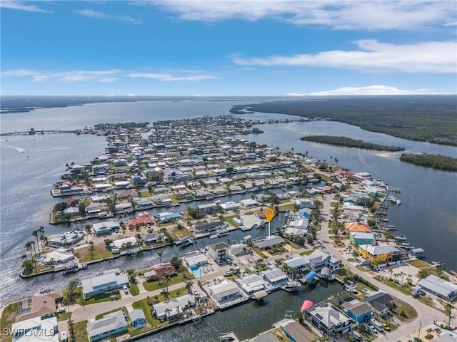 drone / aerial view featuring a water view and a residential view
