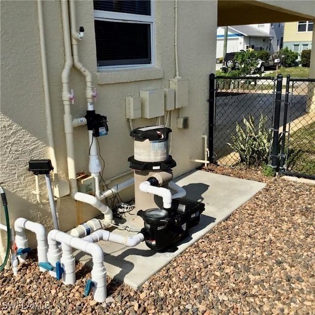 exterior details with fence and stucco siding