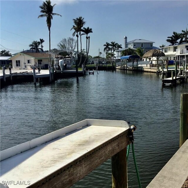 dock area with a water view and a residential view