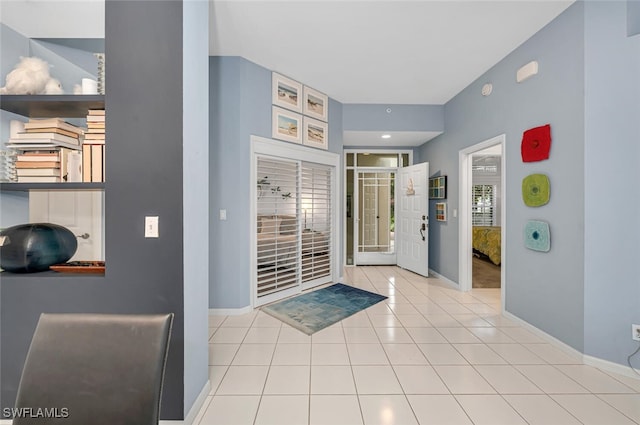 tiled foyer entrance featuring baseboards