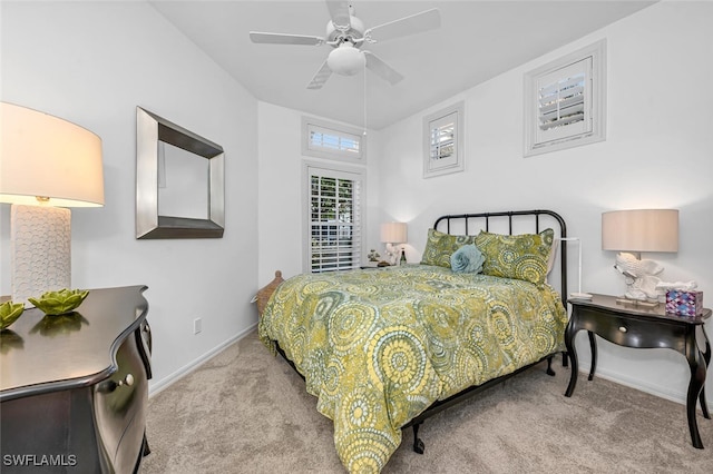 carpeted bedroom featuring ceiling fan and baseboards