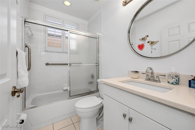 full bathroom with shower / bath combination with glass door, vanity, toilet, and tile patterned floors