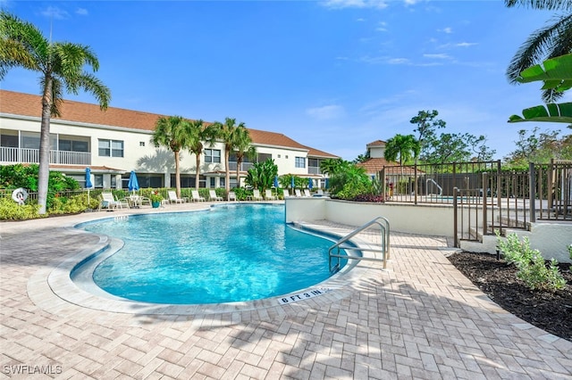 community pool featuring a patio area and fence