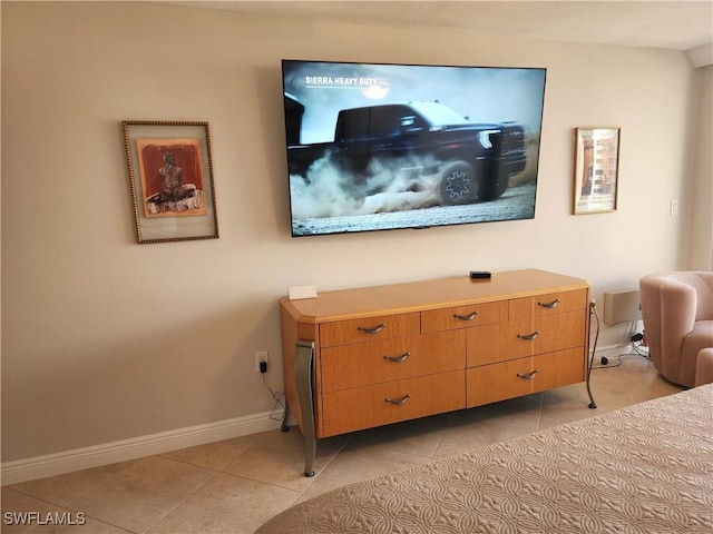 interior space with baseboards and light tile patterned floors