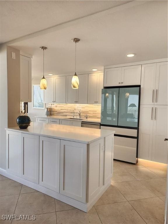 kitchen with stainless steel appliances, a sink, light countertops, and white cabinets