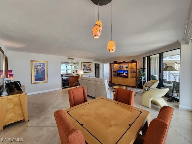 dining area featuring beverage cooler, baseboards, and light tile patterned floors