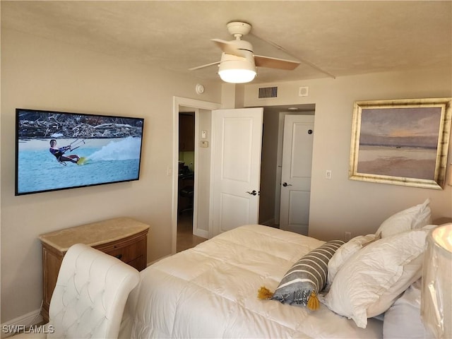 bedroom featuring ceiling fan, visible vents, and baseboards