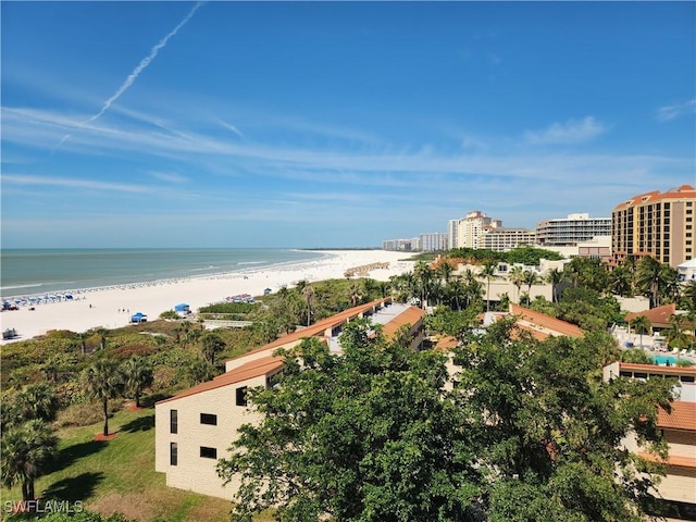 birds eye view of property with a water view and a view of the beach