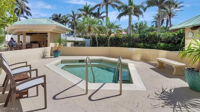 view of pool featuring a patio area, fence, and a community hot tub