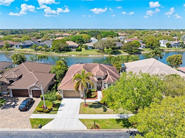 drone / aerial view featuring a water view and a residential view