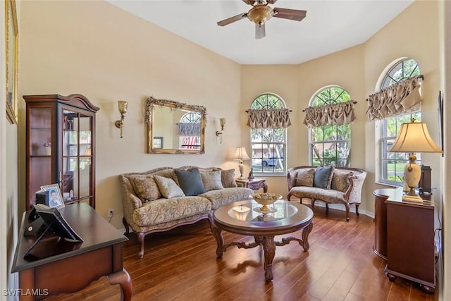 sitting room featuring plenty of natural light, a ceiling fan, and wood finished floors