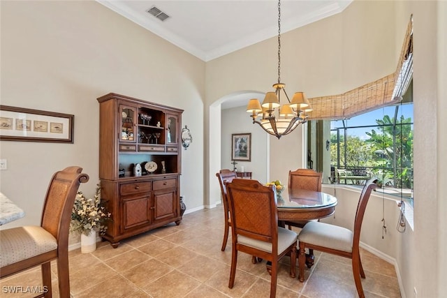 dining area featuring light tile patterned floors, ornamental molding, visible vents, and baseboards