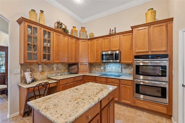 kitchen featuring stainless steel appliances, ornamental molding, and brown cabinets