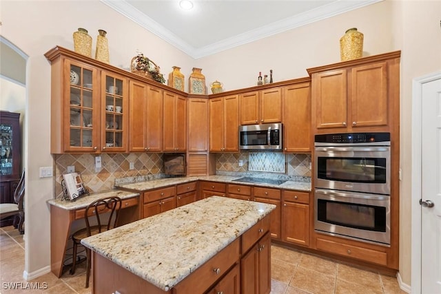 kitchen with appliances with stainless steel finishes, brown cabinetry, ornamental molding, and backsplash