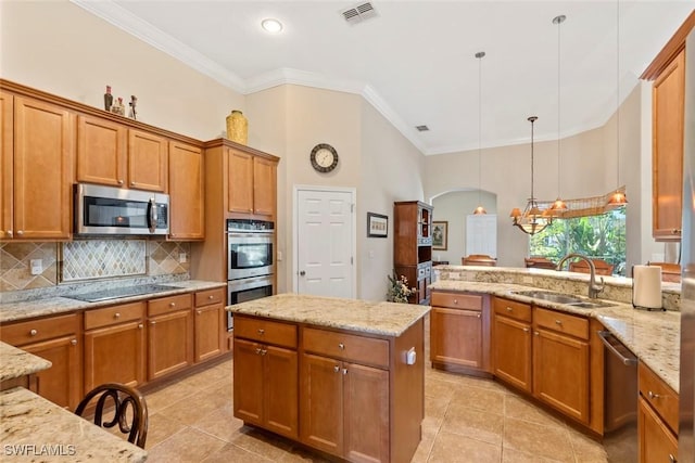 kitchen with stainless steel appliances, brown cabinets, visible vents, and a sink