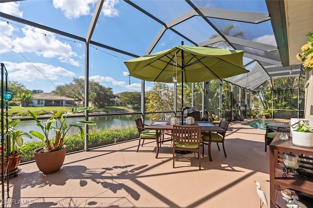 view of patio with a water view, a lanai, and outdoor dining area