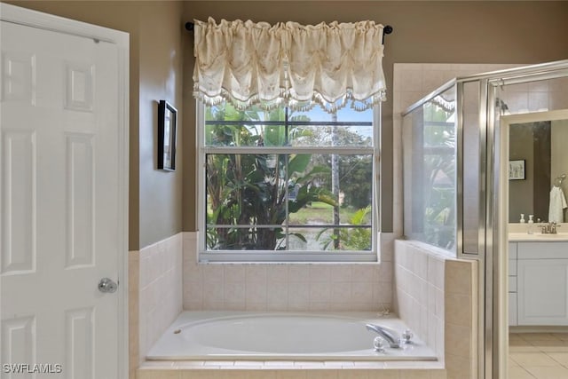 full bath featuring tile patterned floors, a shower stall, a bath, and vanity