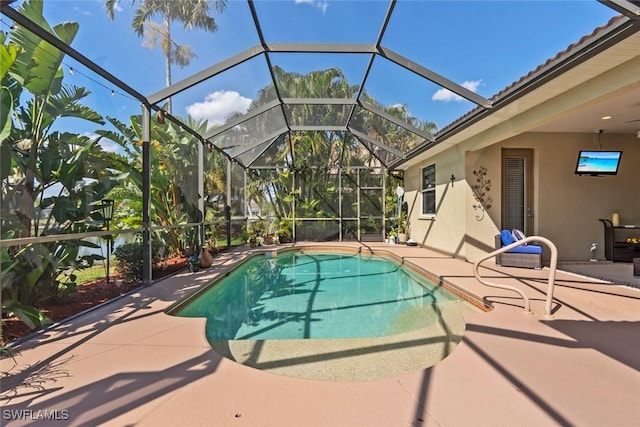 outdoor pool with a patio and glass enclosure