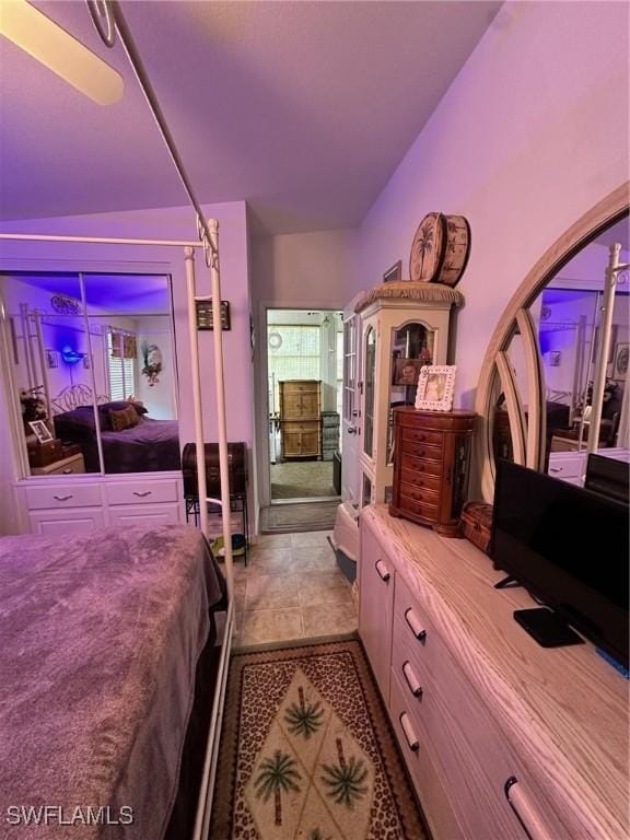 bedroom featuring tile patterned floors and lofted ceiling