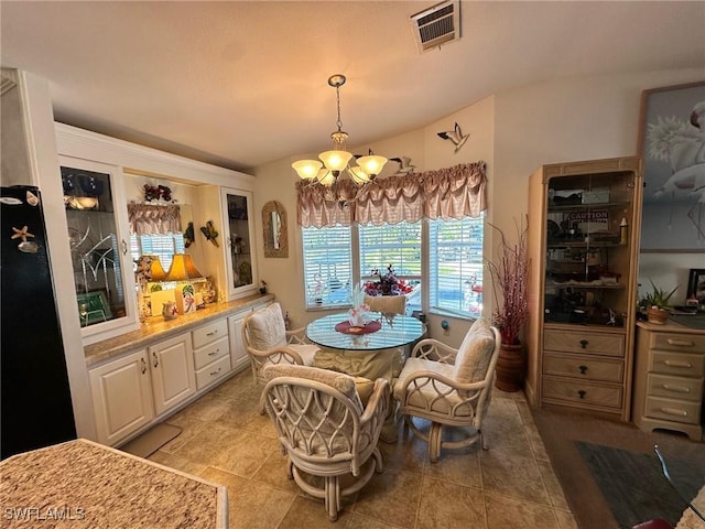 dining space featuring light tile patterned floors, visible vents, and an inviting chandelier