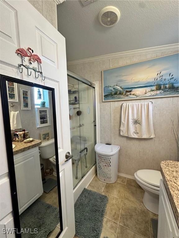 full bathroom with visible vents, toilet, a stall shower, a textured ceiling, and vanity