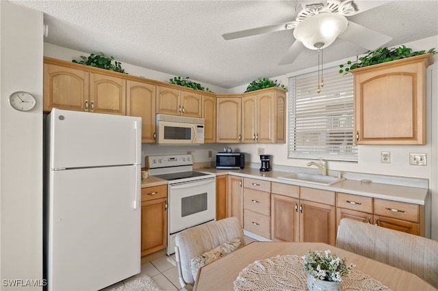 kitchen featuring a sink, white appliances, light brown cabinets, and light countertops