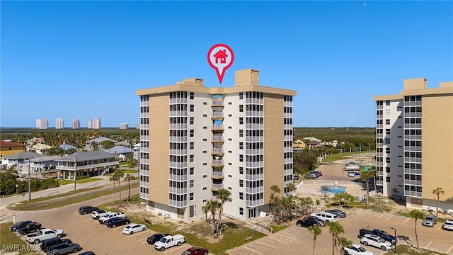 view of property featuring uncovered parking