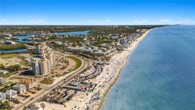 birds eye view of property with a water view and a beach view