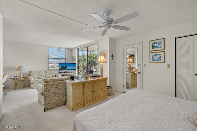 bedroom with light carpet, a textured ceiling, and ceiling fan