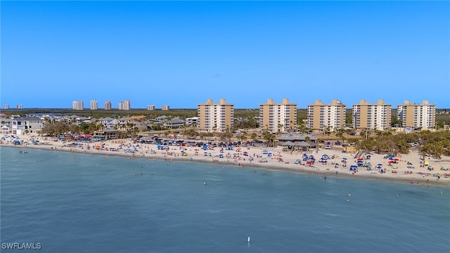 bird's eye view featuring a city view, a view of the beach, and a water view