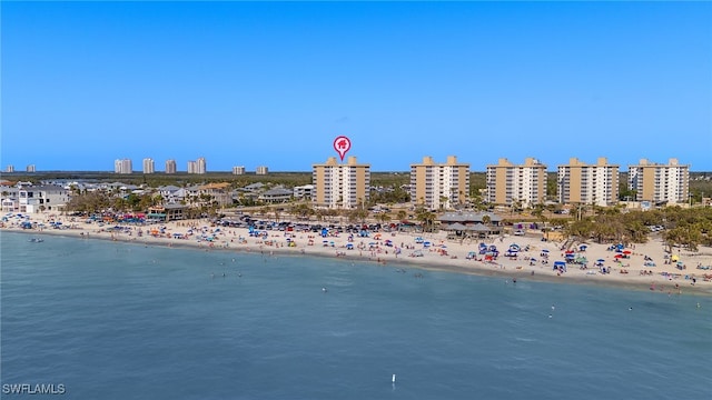 birds eye view of property with a water view, a city view, and a view of the beach