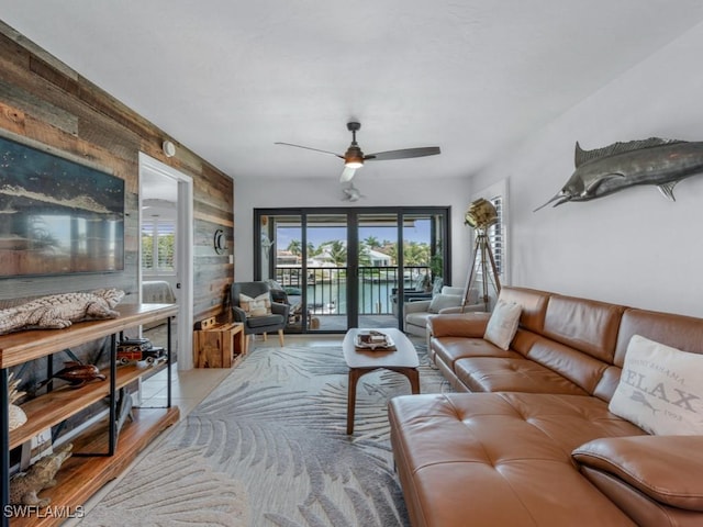 living room featuring wood walls and a ceiling fan