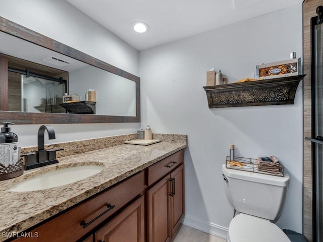 bathroom featuring baseboards, toilet, a shower with door, vanity, and recessed lighting