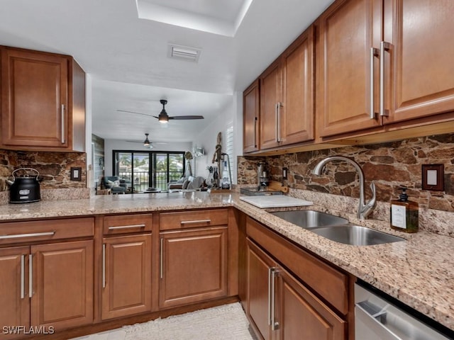 kitchen with a sink, light stone countertops, dishwasher, tasteful backsplash, and brown cabinetry