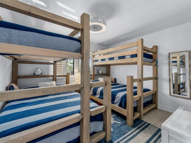 bedroom with tile patterned flooring and baseboards