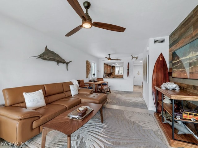 living area with visible vents and ceiling fan