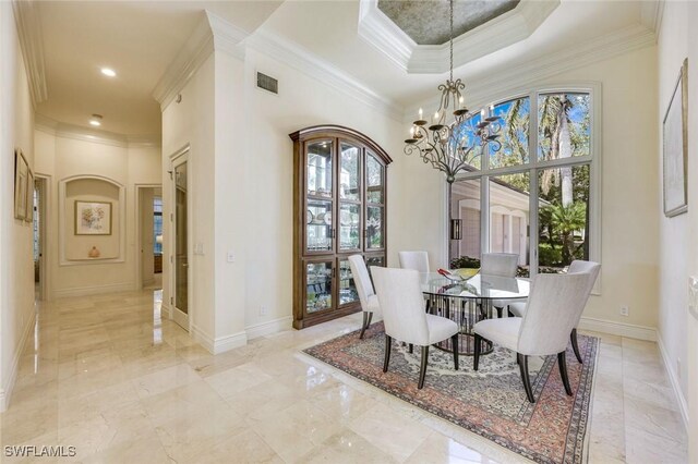 dining area featuring visible vents, baseboards, an inviting chandelier, a raised ceiling, and crown molding