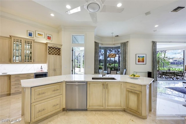 kitchen featuring a sink, light brown cabinets, visible vents, and crown molding